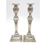 A pair of silver candlesticks hallmarked London 1931, maker Charles Kirkham. Approx. 11" high Please