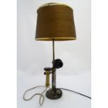 An early 20thC candlestick telephone converted to a table lamp, approximately 25 1/2" tall (