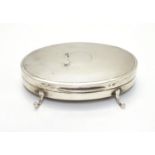 A silver ring box of oval form with engine turned decoration and on 3 feet. Hallmarked Birmingham
