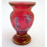 An early 20thC Mary Gregory cranberry glass vase, decorated with an enameled vignette of girl in