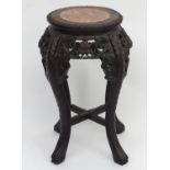 A marble topped jardiniere stand in the Oriental style with floral carved detailing, beaded