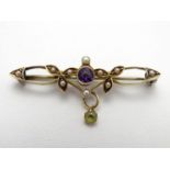 Suffragette jewellery : An early 20thC 15ct gold brooch set with amethyst, seed pearls and peridot (