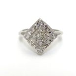 A 14k white gold ring set with 9 diamonds in a squared setting. Ring size approx L Please Note -