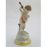 A late 19thC Meissen figure of Cupid holding an arrow and a flaming heart. On a naturalistic base.