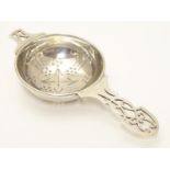 A silver tea strainer hallmarked Sheffield 1965 maker HH. 5" long Please Note - we do not make