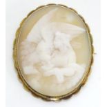 A classical shell carved Cameo brooch depicting scene of Leda and the swan within a 9ct gold