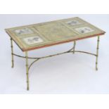 An early 20thC brass based coffee table with exposed oriental tiles to the top depicting figural