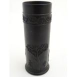 A Wedgwood basalt ware cylindrical vase with classical decoration depicting Apollo in a landscape.