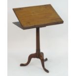 A late 18thC / early 19thC mahogany adjustable reading stand on a pedestal tripod base with cabriole