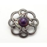 An Irish silver brooch set with central amethyst cabochon. Hallmarked Dublin 1975 1 1/4" Please Note