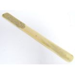 A 19thC Oriental ivory page turner / paper knife with engraved decoration depicting a stylised