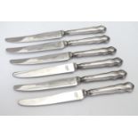 A set of 6 silver handled butter knives, hallmarked Sheffield 1940 maker D&S. Approx 6 1/2" long
