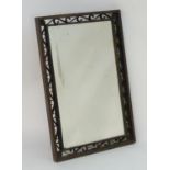 A 20thC mirror with a scrolled bronze surround and a bevelled mirror to the centre. 24? wide x 37?