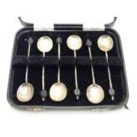 A Cased set of 6 silver coffee spoons with coffee bean decoration to handles. Hallmarked Sheffield