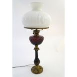Lighting: a late-19thC table oil lamp (converted to electricity), the lobed milk glass shade