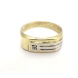 A 9ct gold ring wit yellow and white gold decoration and diamond detail. Ring size approx size S