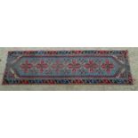 Carpet / Rug : A runner with pale blue ground with banded geometric red, brown and bright blue
