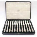 A cased set of twelve silver handled tea / butter knives, hallmarked Sheffield 1917, maker Walker