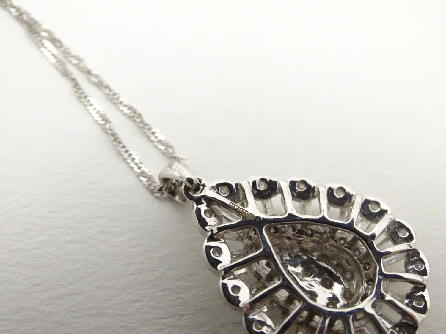 A 9ct white gold pendant set with a profusion of diamonds, on an 18" long and. The pendant approx 1" - Image 7 of 7