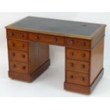 A 19thC mahogany double pedestal desk with an inset top above a single central drawer flanked by a