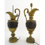 A pair of early-20thC table lamps formed as wine ewers, decorated in ormolu with putti and