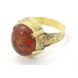A 19thC Yellow metal ring ( tests as gold) set with carnelian cabochon with primitive carved
