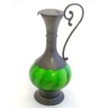 A French Art Nouveau style ewer with a green glass body and French pewter mounts, stamped with Etain