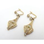 A pair of late 19thC / early 20thC gold drop earrings set with diamonds and pearls. Approx 1 1/2"