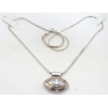 A silver pendant on chain, the lozenge shaped pendant set with a similarly contoured single white
