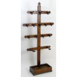 A late 19thC oak hall stand with Gothic motifs and shaped hooks, having four parallel cruciform