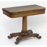 A mid 19thC mahogany pedestal card table with a rotating and opening rectangular top containing a