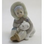 A Lladro figure of an Eskimo girl with a polar bear, model no. 1195. Marked under. Approx. 4 3/4"