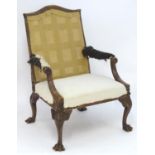 A late 18thC Irish walnut armchair for re-upholstery. The chair raised on four carved cabriole