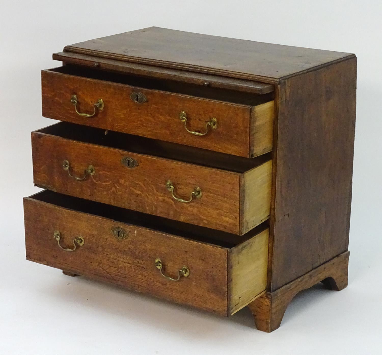 A mid 18thC oak chest of drawers with a rectangular top above a brushing slide and three long - Image 5 of 7