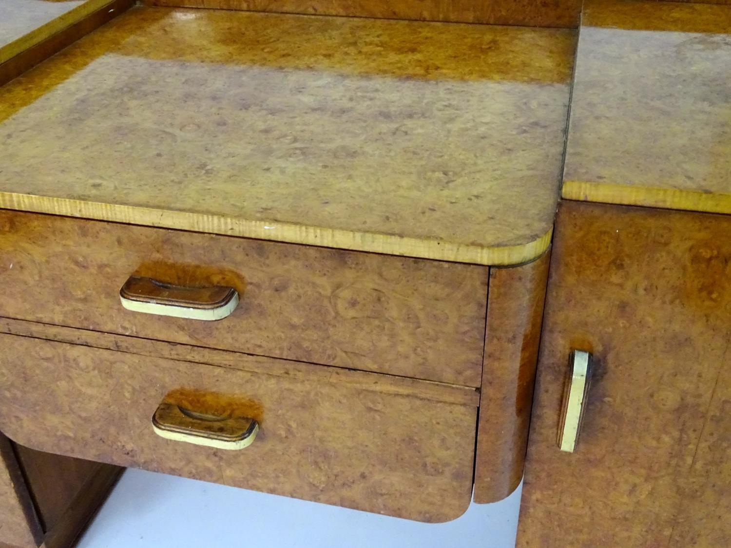 A mid 20thC burr walnut dressing table with two short drawers flanked by cupboards to each side. 48" - Image 5 of 7