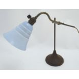 An early 20thC Art Deco desk lamp, the arm affixed to the stem by an adjustable bracket, with fluted