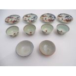 Four Oriental tea bowls and saucers in the Imari palette, decorated with a landscape scene with an