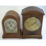 Two late 19thC early 20thC mantle clocks, one in an arch shaped case, the other walnut cased with