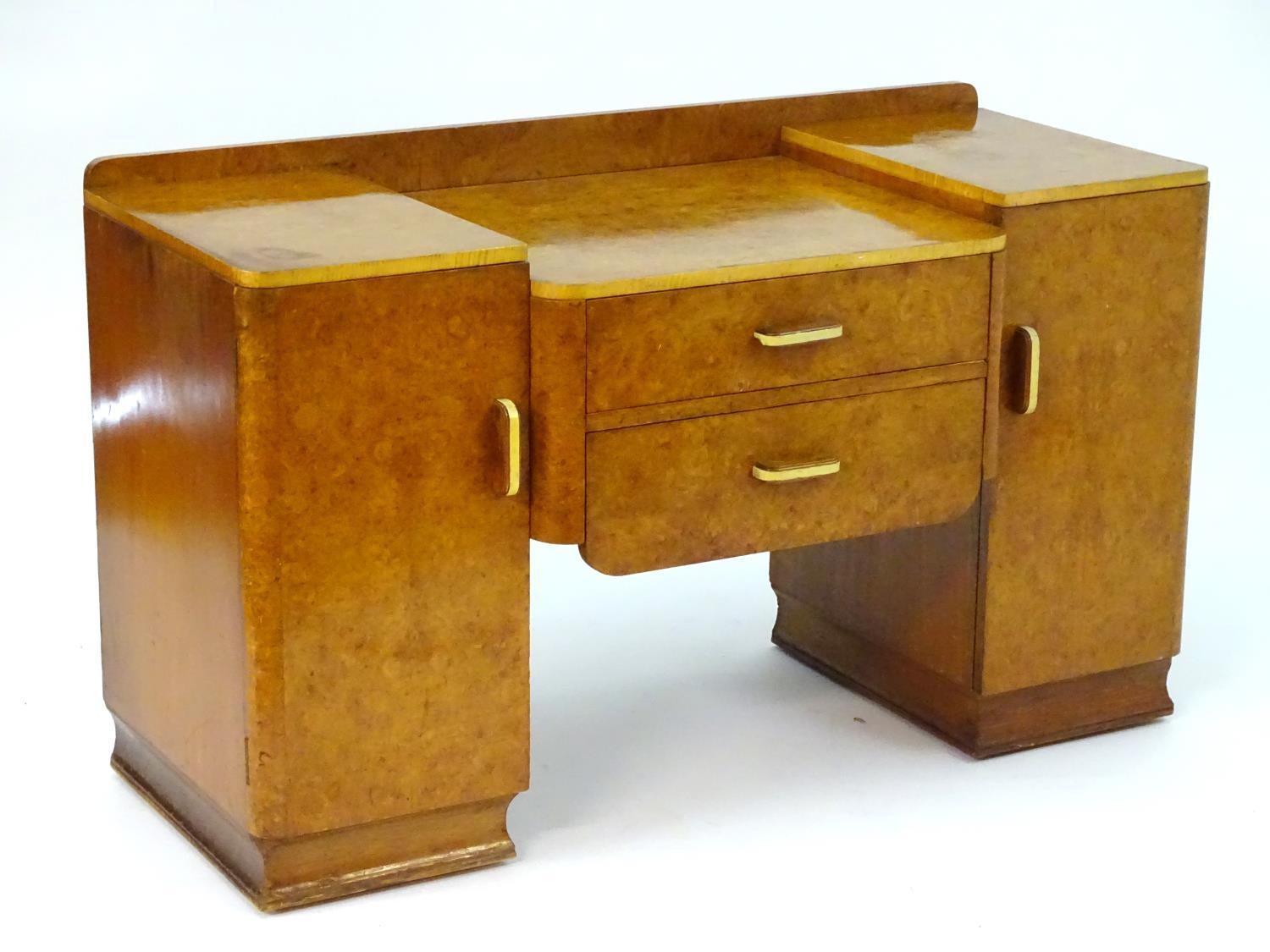 A mid 20thC burr walnut dressing table with two short drawers flanked by cupboards to each side. 48" - Image 2 of 7