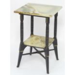 An Aesthetic movement table with two onyx tiers and an ebonised frame with gilt highlights, the