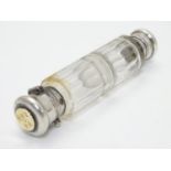 A 19thC double ended scent bottle / flask the class body with with white metal ends and yellow metal