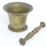 A late 18thC bronze pestle and mortar, measuring 6 1/8" long and 3 1/2" tall respectively Please