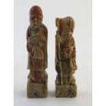Two Oriental soapstone figures depicting an elder / scholar, and a man in robes with a fan.