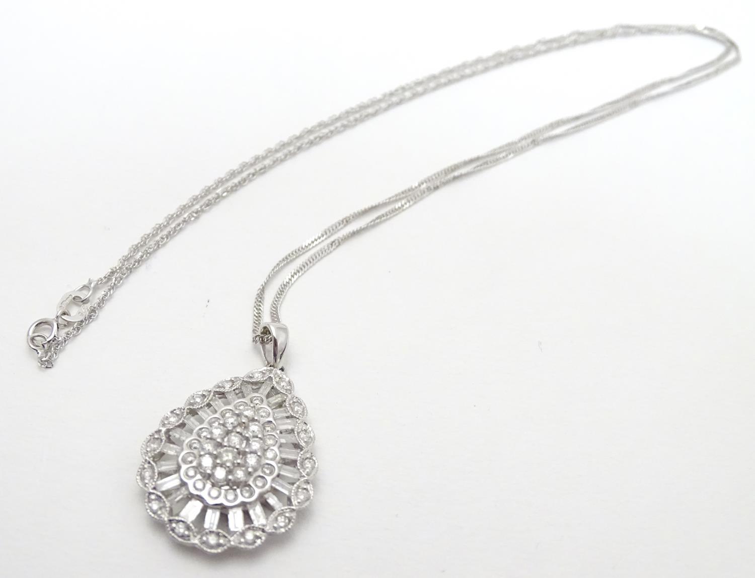 A 9ct white gold pendant set with a profusion of diamonds, on an 18" long and. The pendant approx 1" - Image 4 of 7