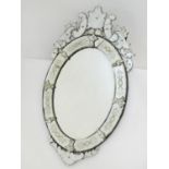 A 19thC Venetian style mirror with floral decoration and adornments. 27" wide x 47" high Please Note
