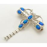 An Arts and crafts style brooch formed as a dragon fly set wit opalescent cabochon. 21stC 1 3/4"