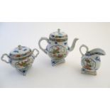 A Japanese teapot, twin handled sugar bowl and milk jug decorated with hand painted insects and