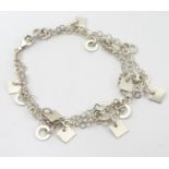 A silver and white metal triple-chain bracelet, each strand mounted with alternating squares and