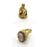 A 19thC gilt metal pendant fob seal with engraved purple stone seal under 3/4" high Please Note - we