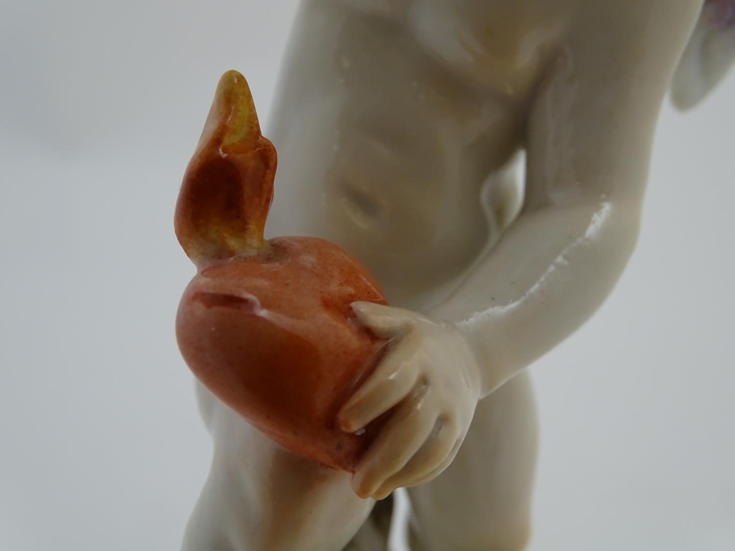 A late 19thC Meissen figure of Cupid holding an arrow and a flaming heart. On a naturalistic base. - Image 7 of 9